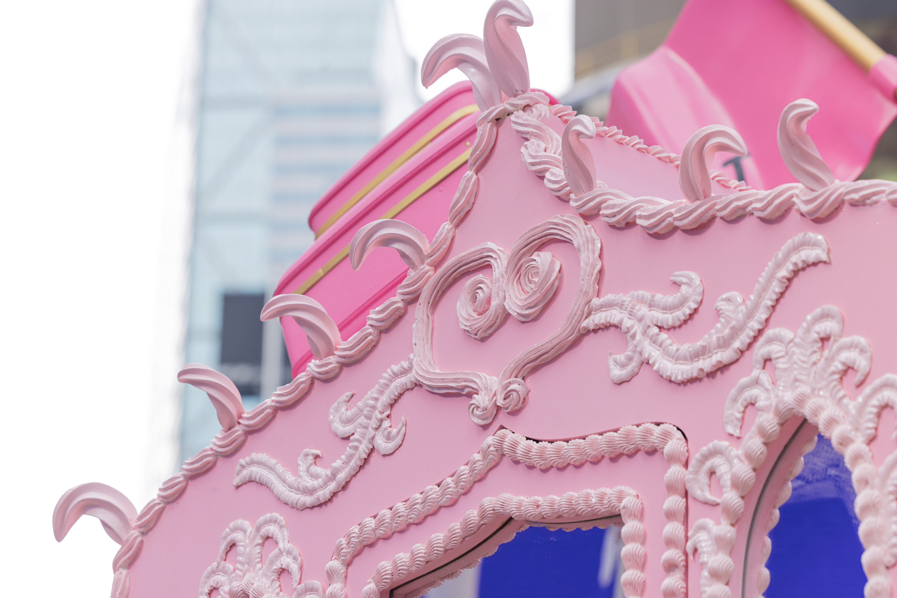 A close-up of a pink carriage with ornate detailing.