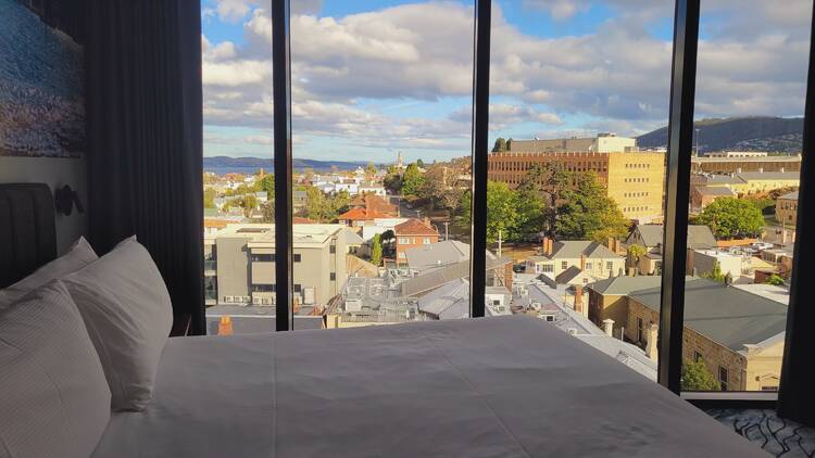 A bed with a view of a town