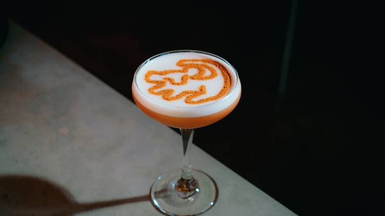 Lion's Pride cocktail with a cinammon topping meant to look like Simba from the Lion King