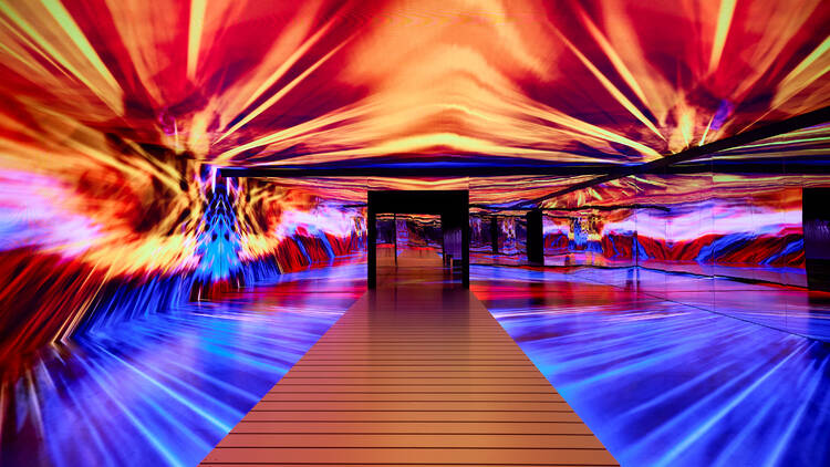 A colorful digital art installation with red, yellow, and blue hues.