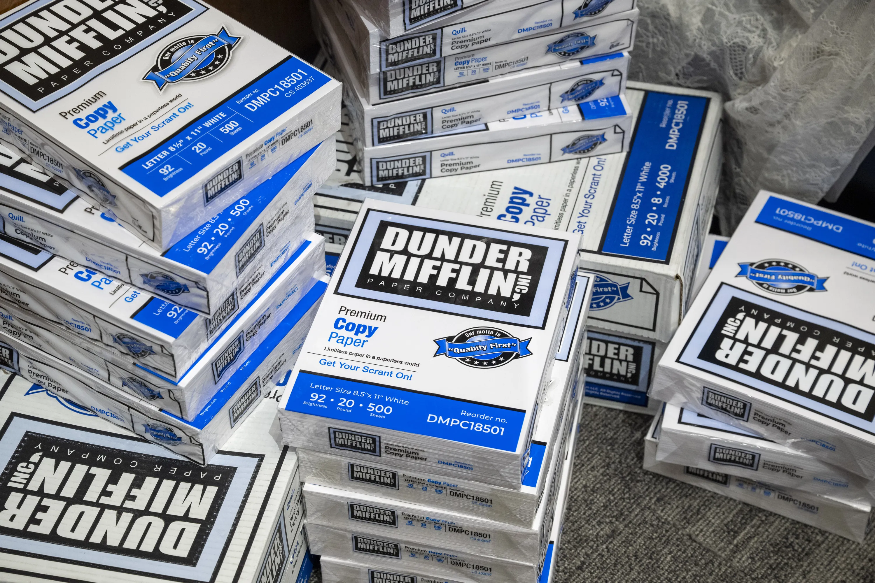 stacks of "Dunder Mifflin" paper