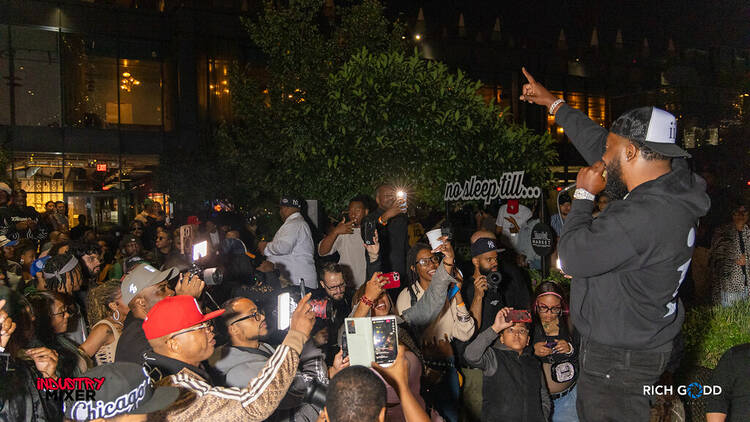 The Industry Mixer A host calling out to a crowd of people at Time Out Market New York's marketplace
