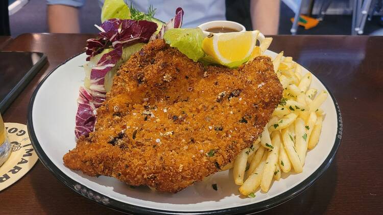 Marrickville Golf Club - Wharf St Kitchen A big chicken schnitzel on a plate