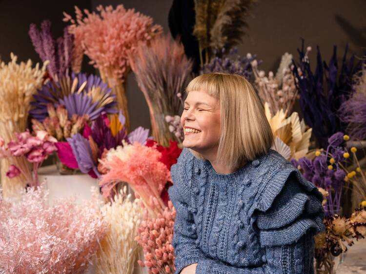 Creative portrait surrounded by vibrant dried flower arrangements at Blomma Creatives studio in Turku, showcasing floral artistry and natural textures. Creative portrait surrounded by vibrant dried flower arrangements at Blomma Creatives studio in Turku, showcasing floral artistry and natural textures.
