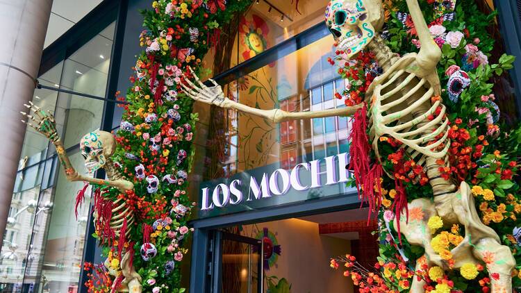Day of the Dead skeletons and flowers outside Los Mochis restaurant  Day of the Dead skeletons and flowers outside Los Mochis restaurant