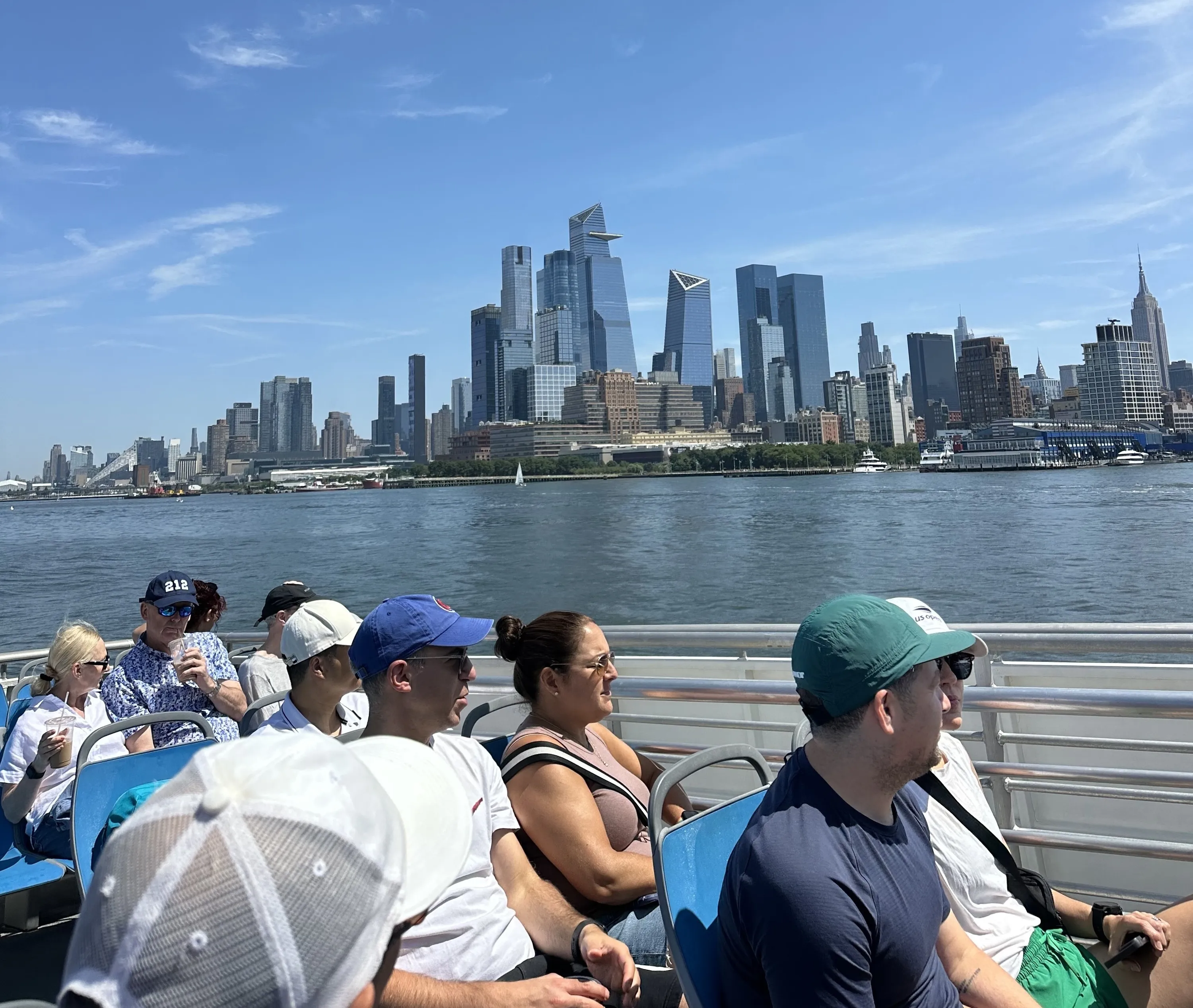 People sit on the IKEA Ferry with a view of the NYC skyline.