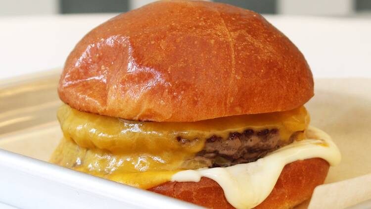 Deux Luxe A burger on a metal tray