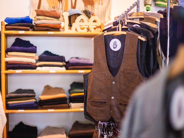 Stylish and neatly arranged clothing display with vests and folded apparel at Hay Second Hand store in Tampere, Finland. Stylish and neatly arranged clothing display with vests and folded apparel at Hay Second Hand store in Tampere, Finland.