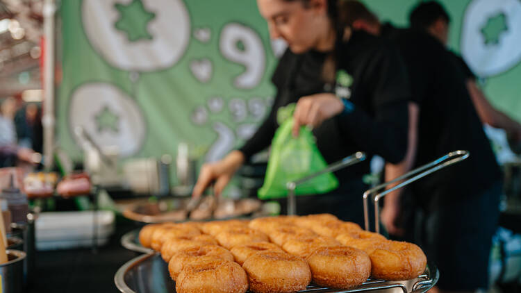 Donut Festival A person cooking cinnamon doughnuts.