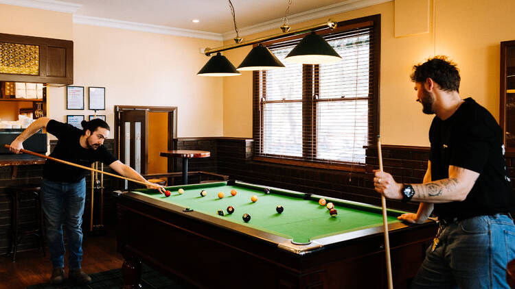 The Yack Hotel Two people playing pool at the Yack Hotel.