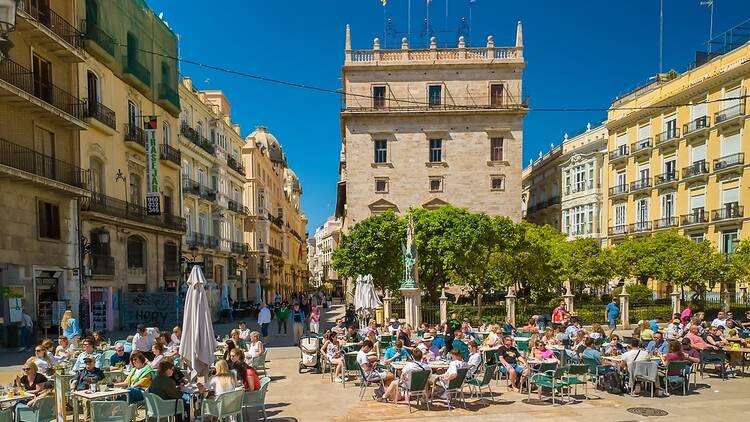 Valencia, Spain - people sitting in a square Valencia, Spain - people sitting in a square