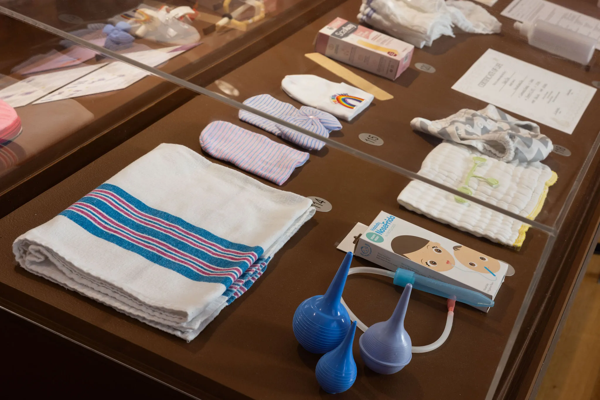 A collection of baby items, including baby blankets and hats.