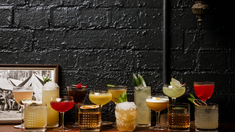 Button Bar Cocktails lined up along a wall
