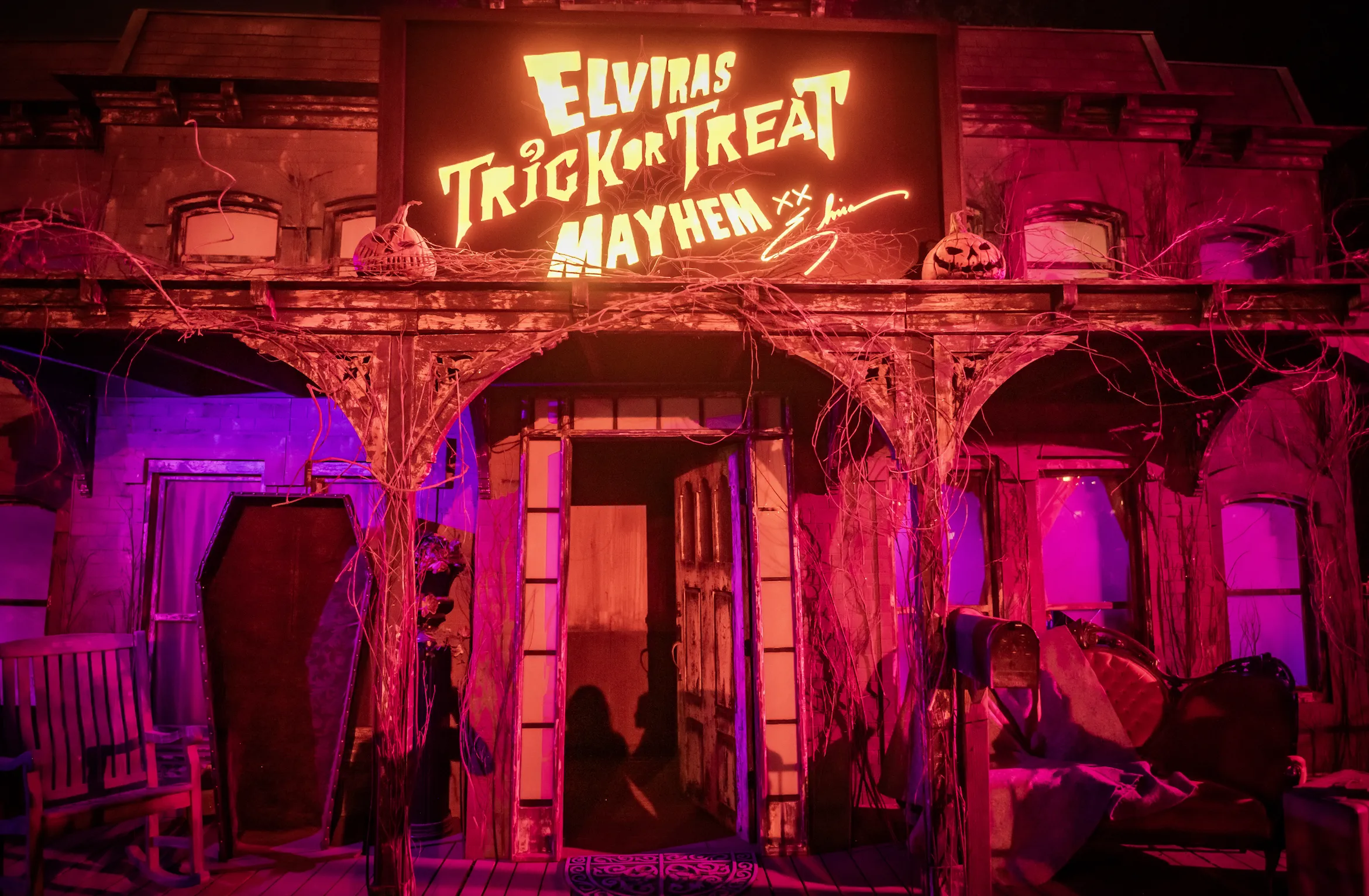 A haunted house facade that reads, "Elvira’s Trick or Treat Mayhem."
