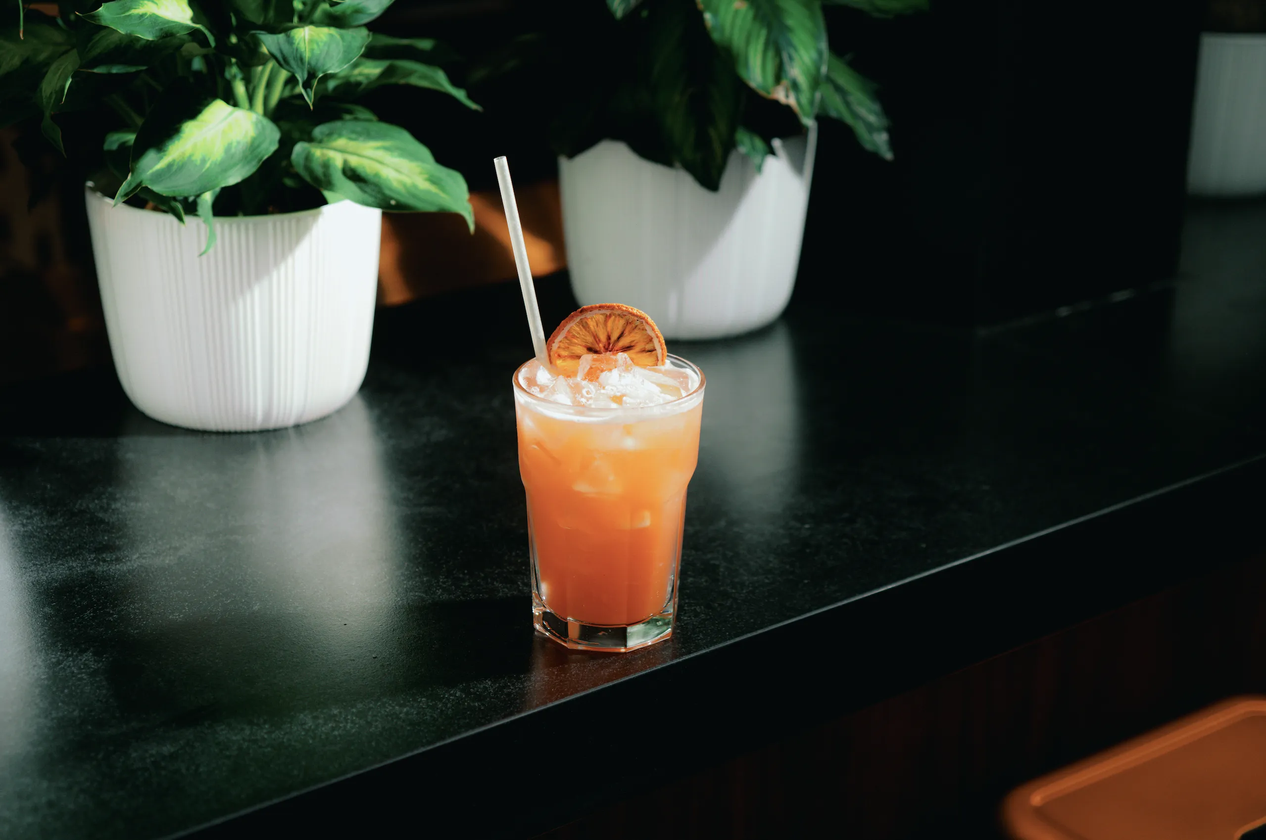 A rum cocktail on black background