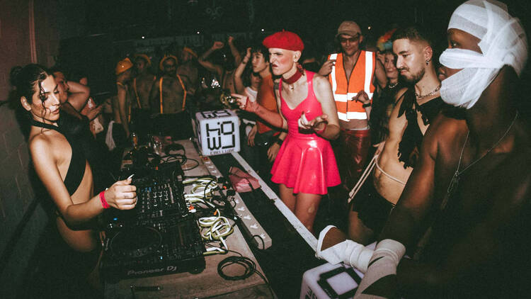 Howloween 2024 A crowd of ravers, some in fancy dress, dancing in front of the decks at Howloween 2024