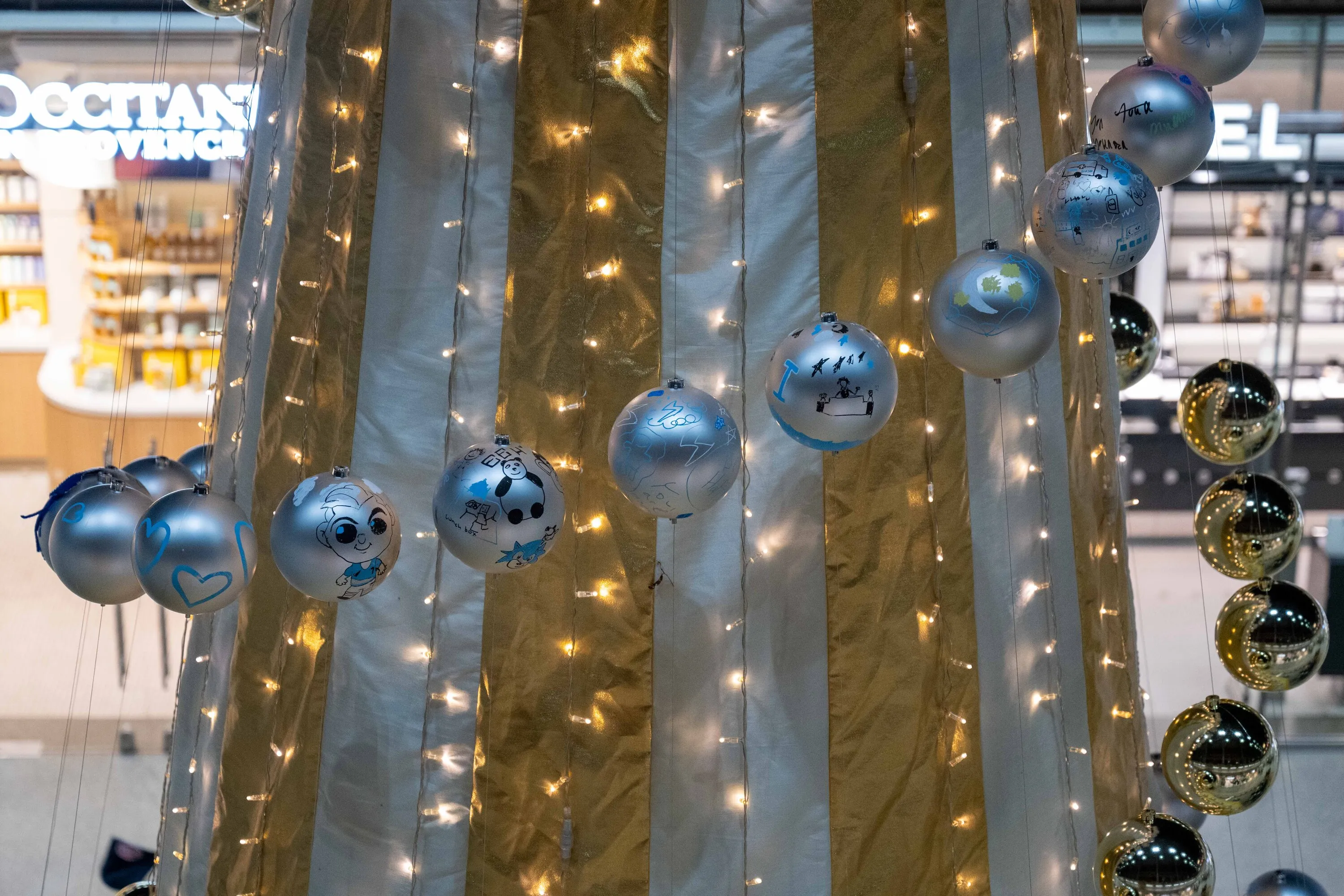 Close up of baubles on the St Pancras Christmas tree 2025
