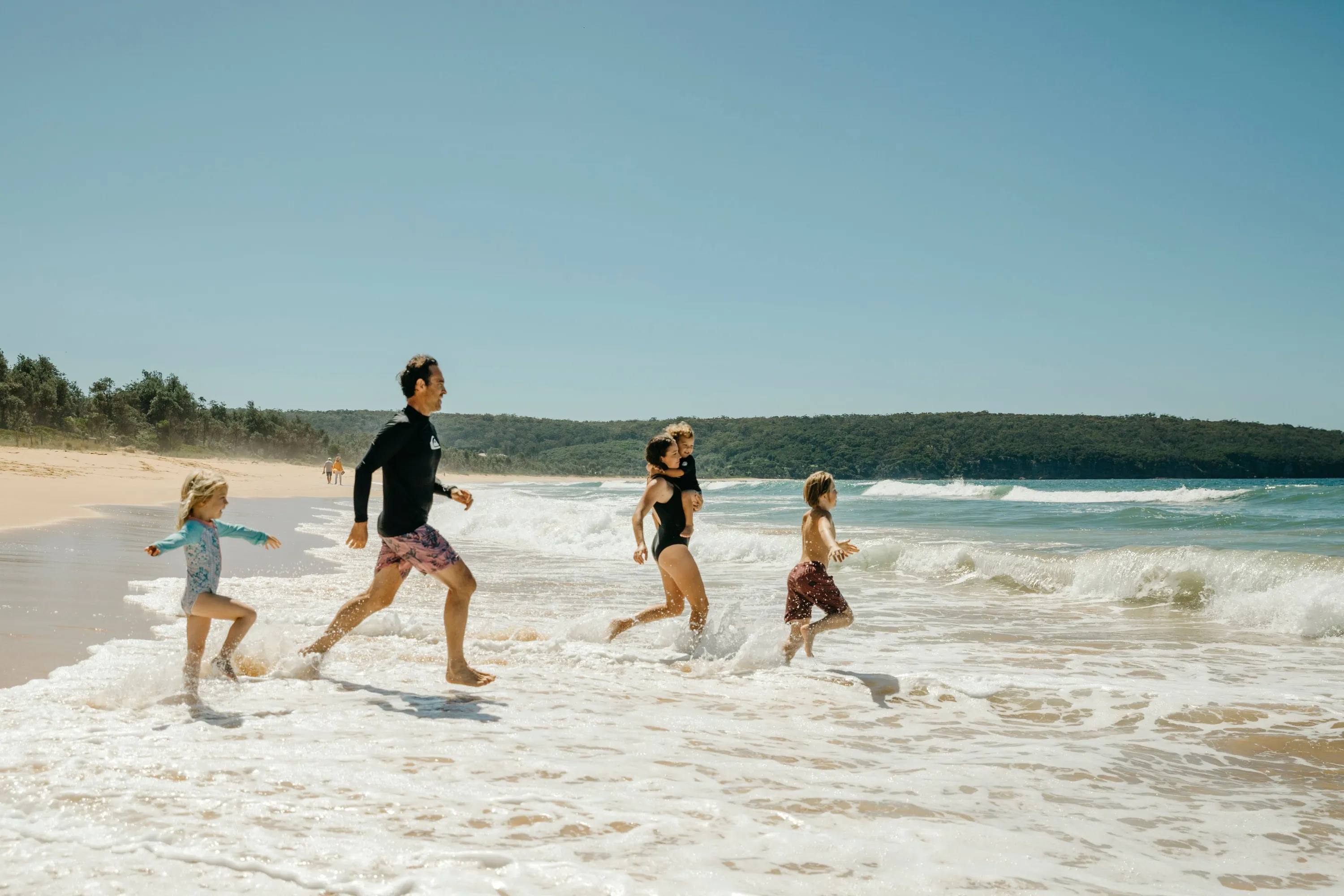 Family enjoying a swim at Aslings Beach in Eden
