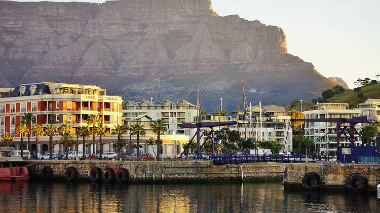 Wharf at Cape Town City Center on a sunny Day with Bascule Bridge, Cape Grace Hotel and Table Mountain National Park in the Background. Wharf at Cape Town City Center in the Sunset