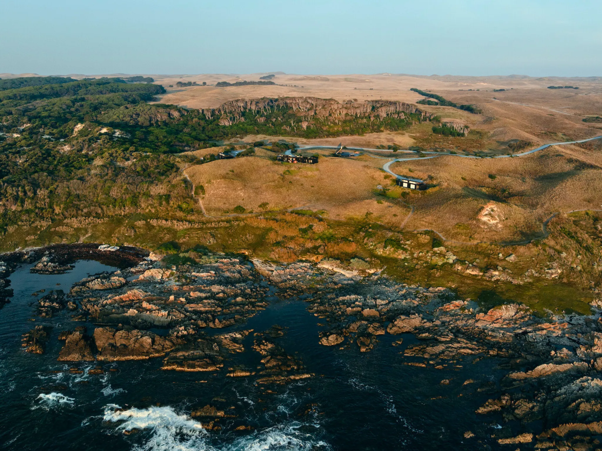 Aerial view of lodges on rugged island