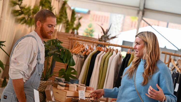 A woman purchasing a gift at a holiday market A woman purchasing a gift at a holiday market