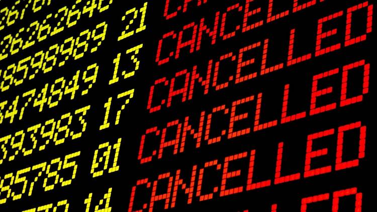 Cancelled flights on airport board Cancelled flights on airport board