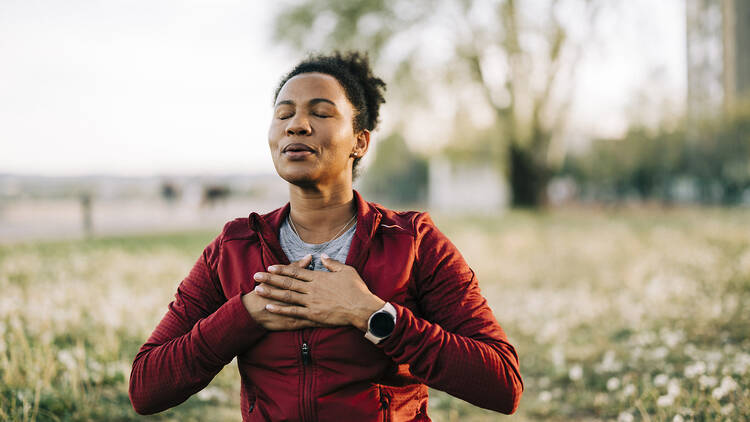 Woman, breath and hand on chest, for meditation and wellness being peaceful to relax 2149153835