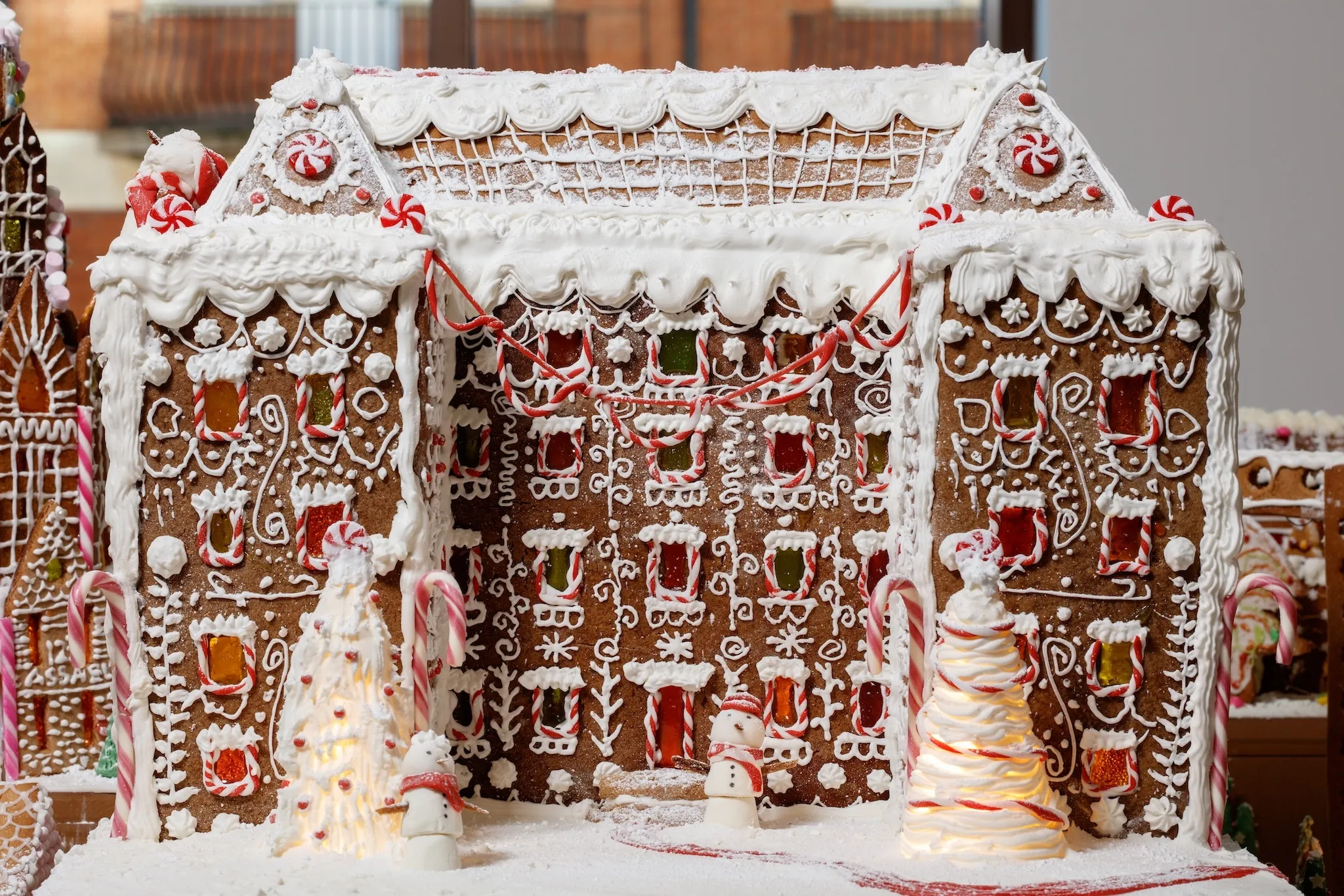 A large gingerbread building made of candy canes and frosting