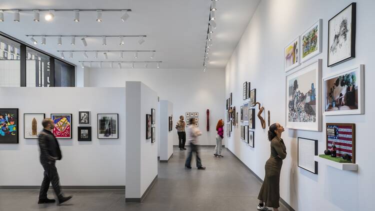 People look at artwork inside The Studio Museum in Harlem.