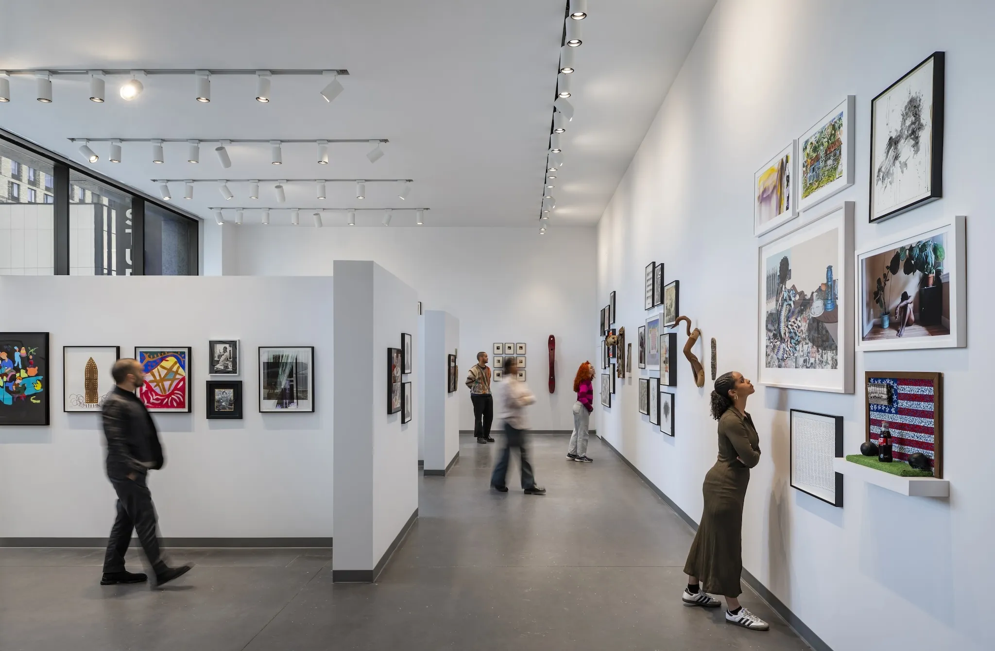 People look at artwork inside The Studio Museum in Harlem.