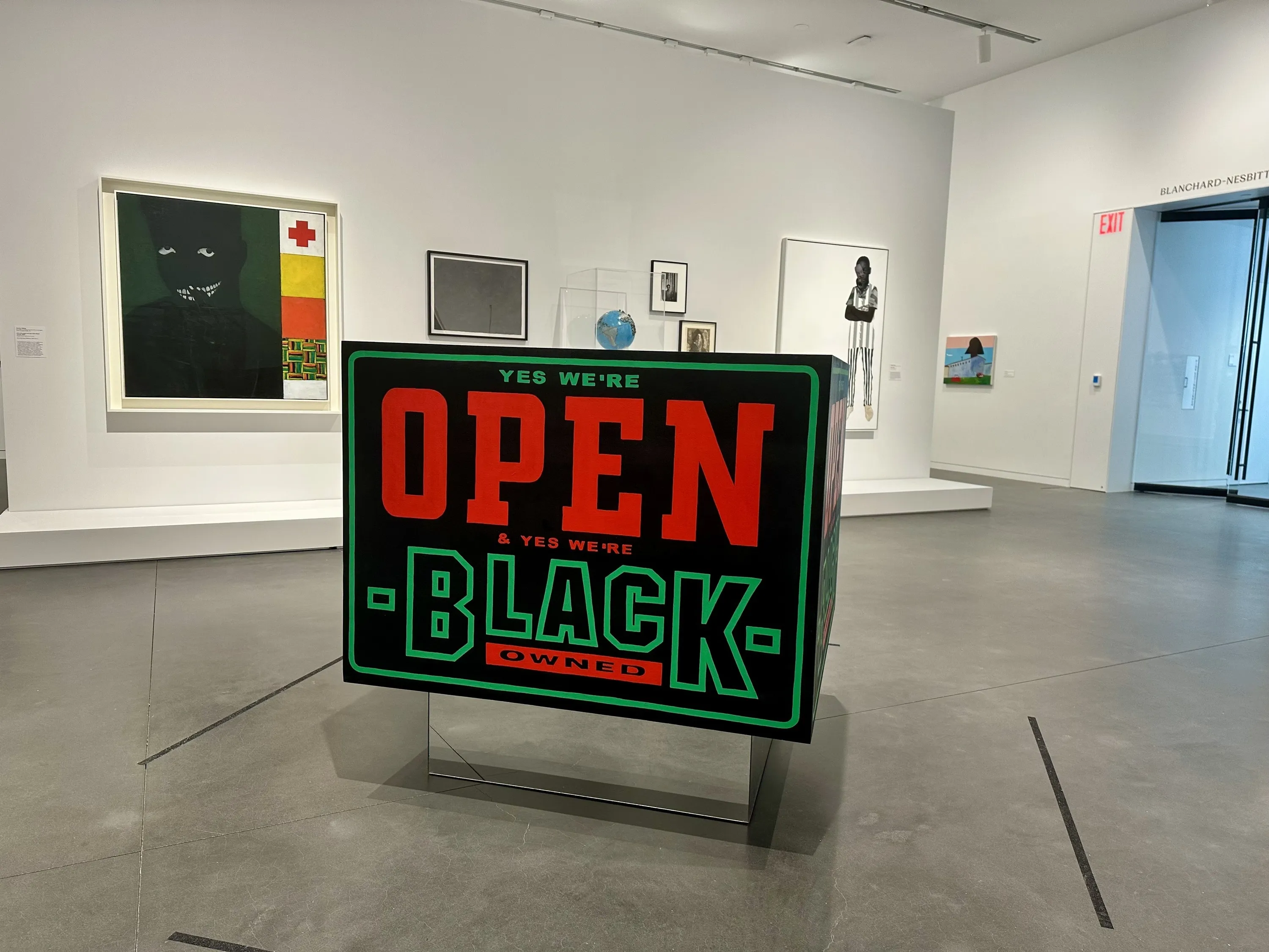 A piece of artwork in the Studio Museum reading "yes we are open and yes we are Black-owned"
