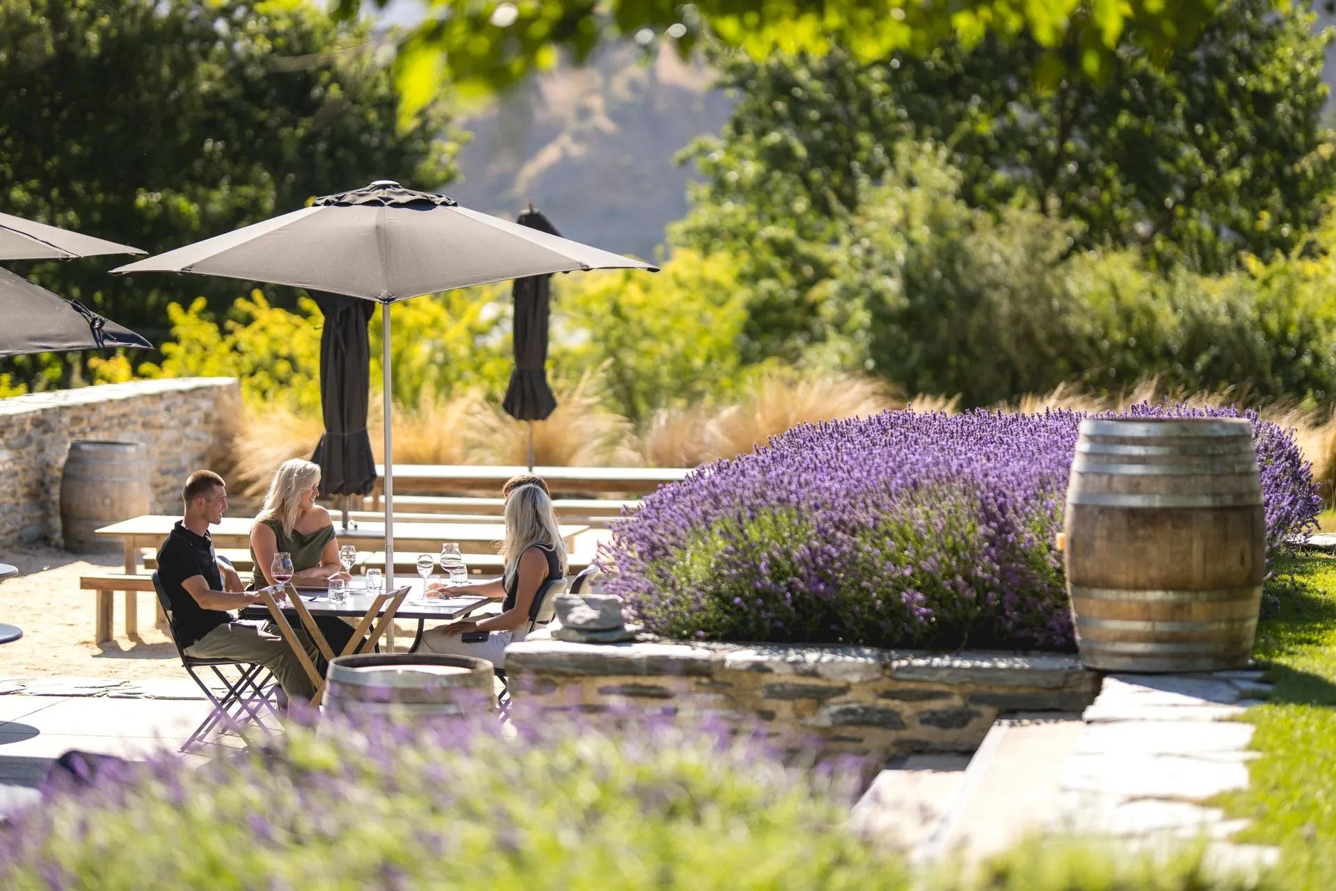 People dining in garden with lavender