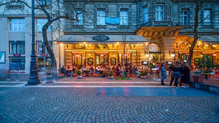 People eating in the street in Budapest People eating in the street in Budapest