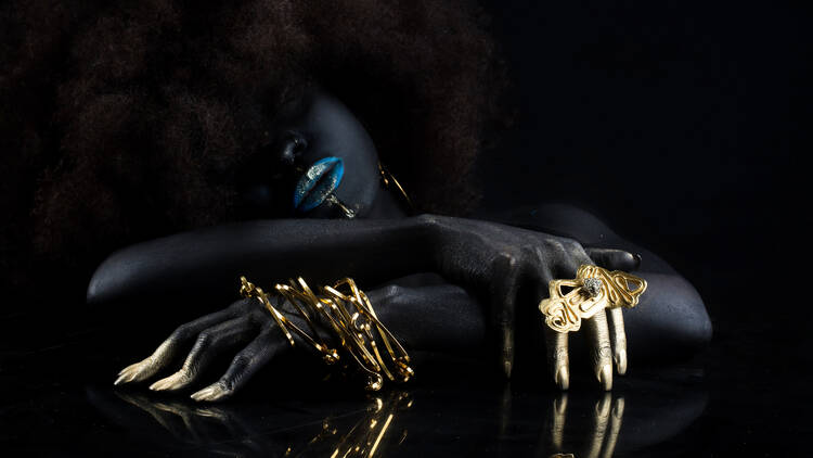 A woman wears golden jewelry.