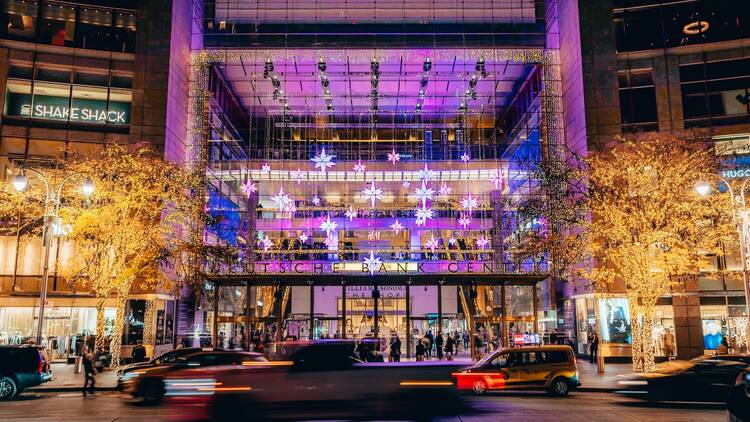 An exterior view of The Shops at Columbus Circle with holiday lights. An exterior view of The Shops at Columbus Circle with holiday lights.