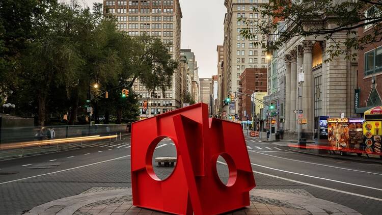 An abstract red sculpture in Union Square that looks like a book.