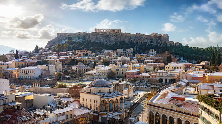 View over the snow covered old town Plaka of Athens, Greece, to the Parthenon Temple of the Acropolis on a cold winter day
