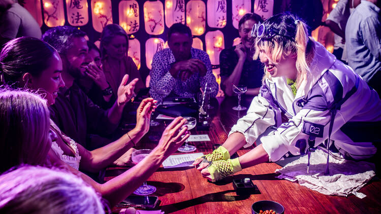 A magician performing tricks at a bar