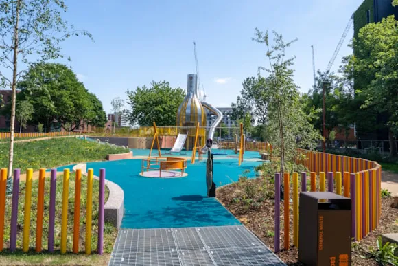 Architect image of a bright playground with a futuristic slide and roundabout