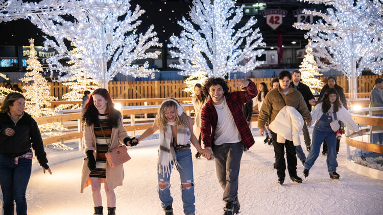 People skating on a pop-up ice rink.