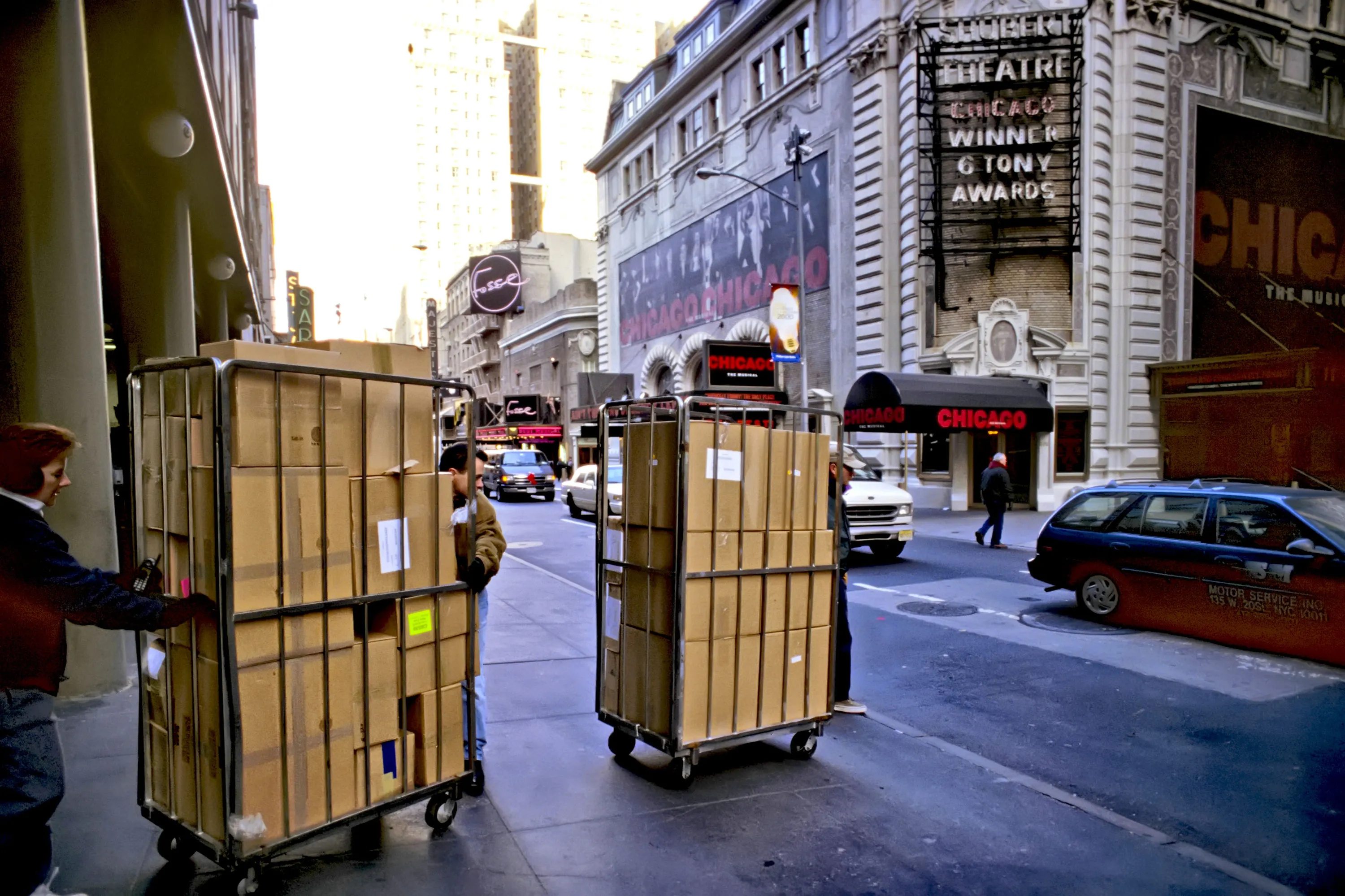Volunteers surreptitiously push 3,000 pounds of confetti in brown boxes through the streets.