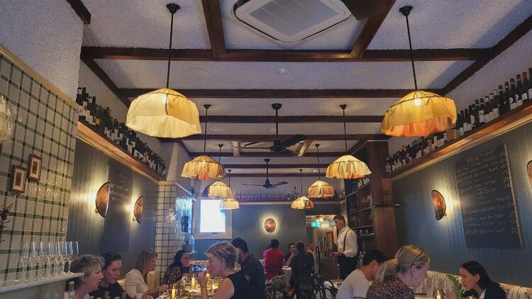 A dining room with ruffled pendant lamps