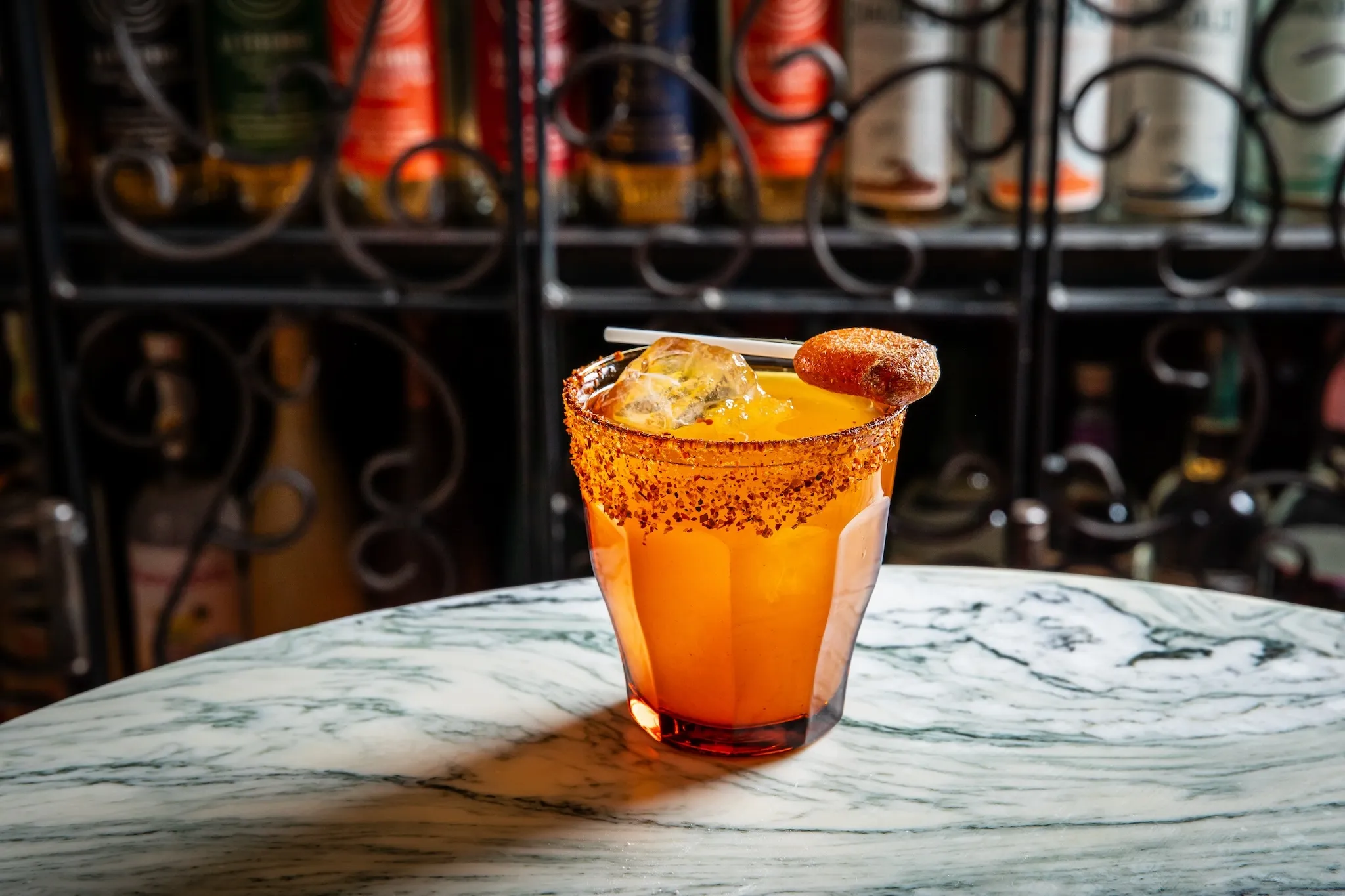 A cocktail with a chamoy lollipop