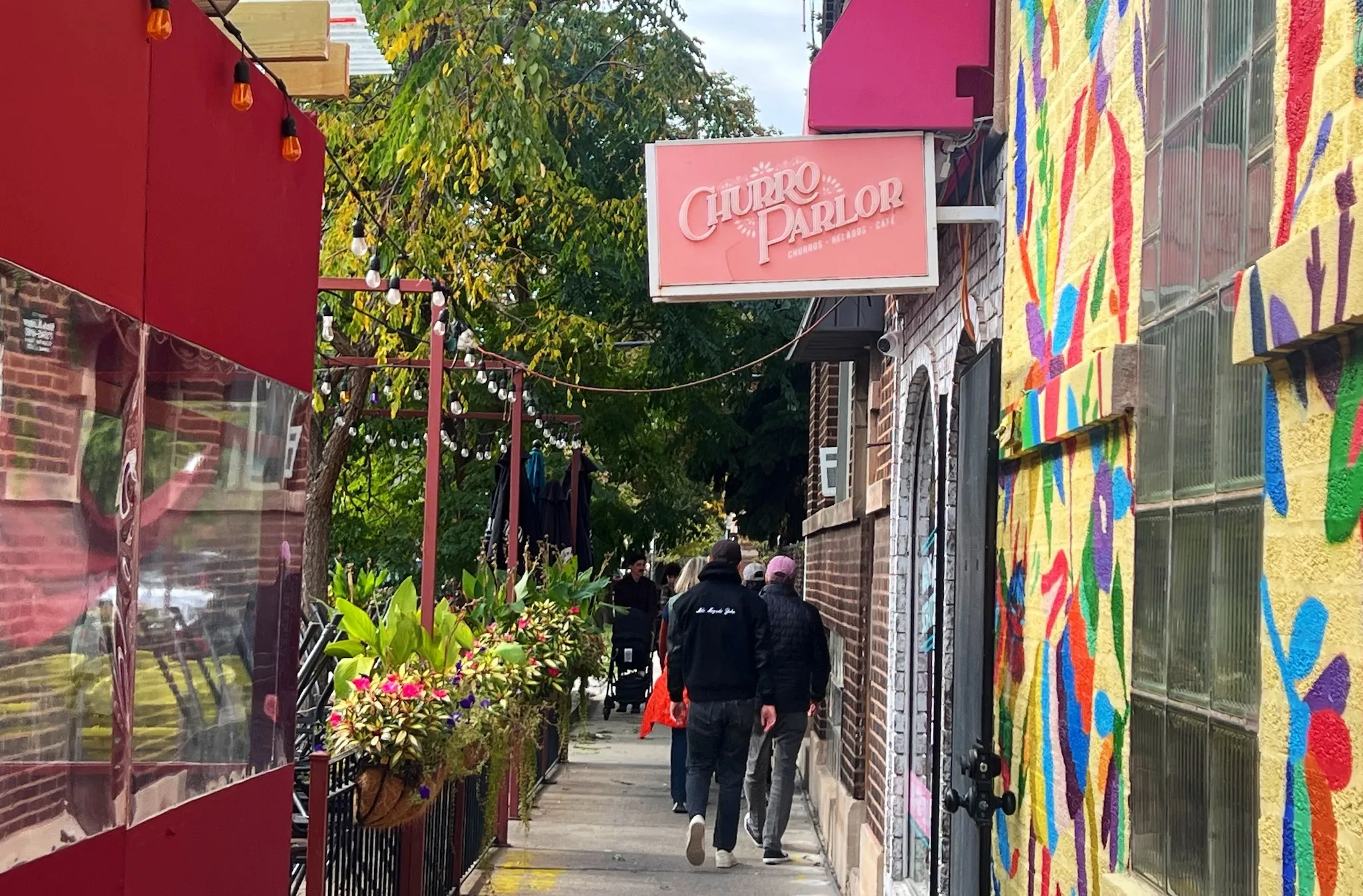 People walk down Roscoe Street in Roscoe Village.
