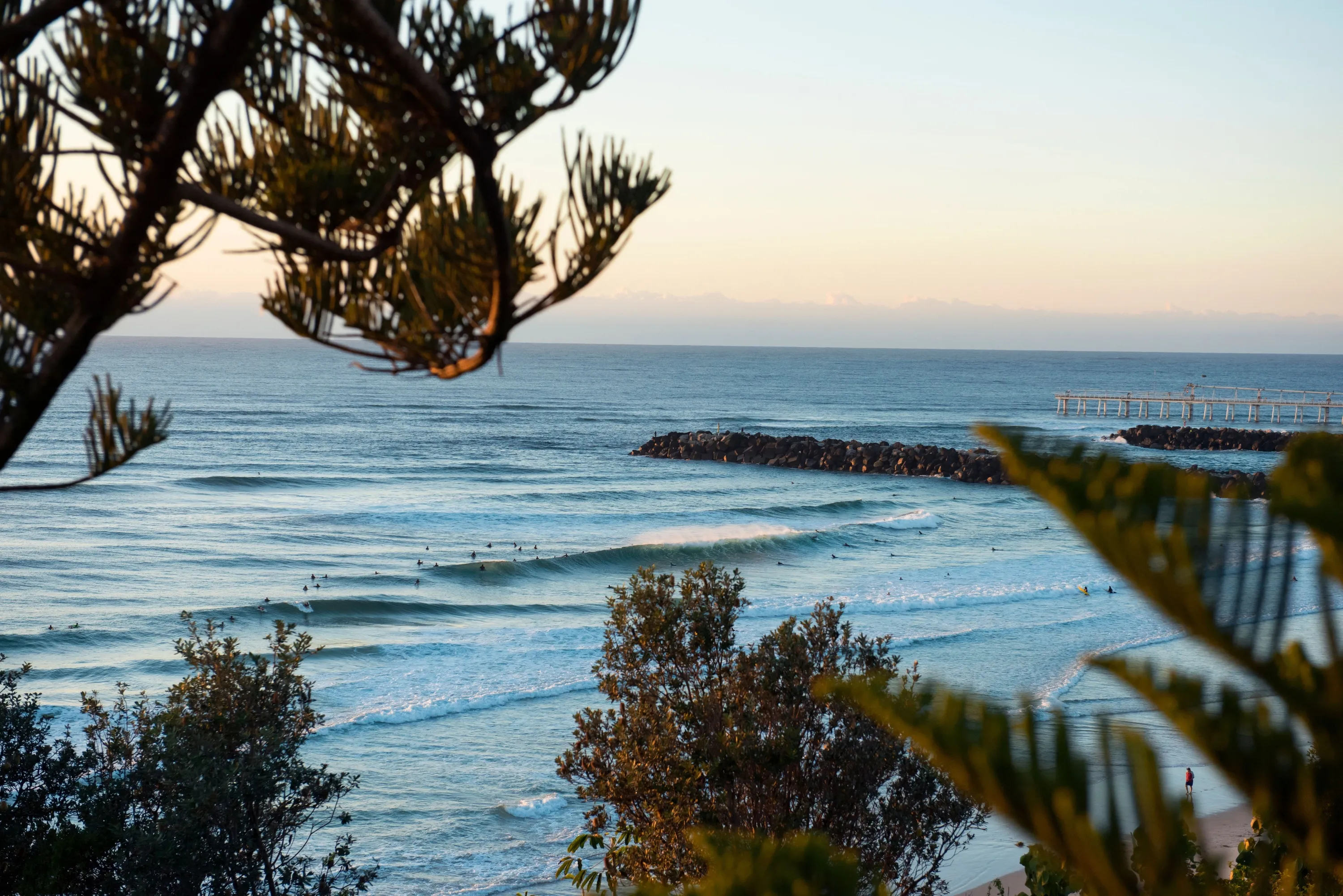 Surfers catching a morning wave at Duranbah Beach, Tweed Heads.