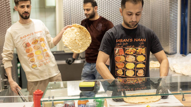 Men working behind the counter at Baban’s Naan Men working behind the counter at Baban’s Naan