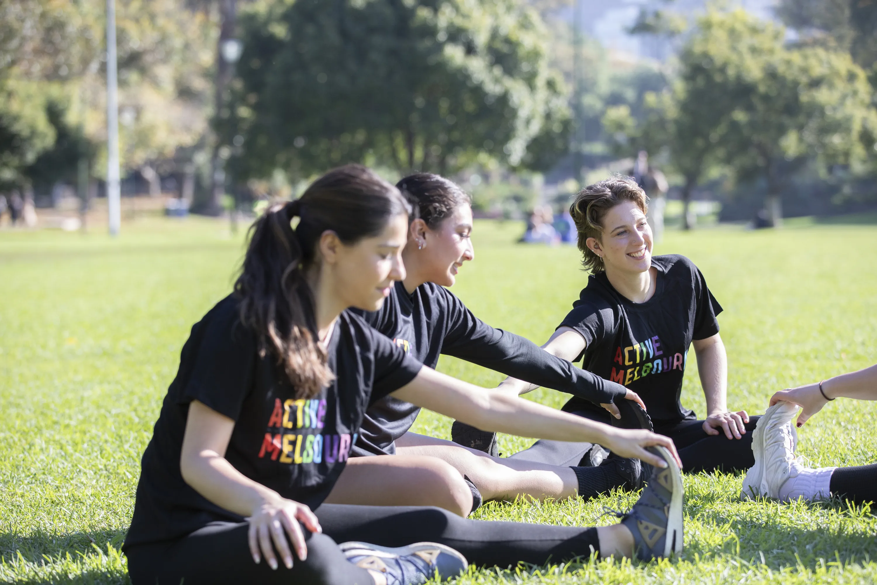 people stretching in Melbourne park