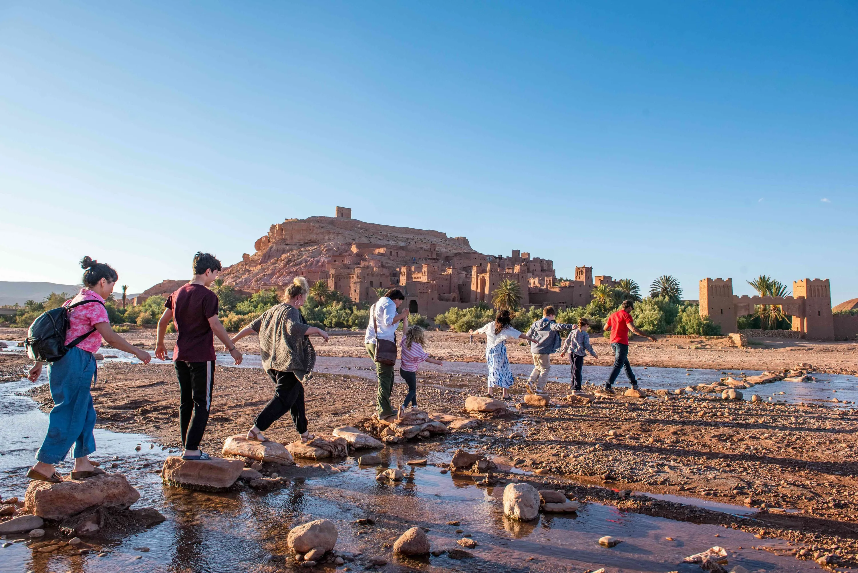 Family crossing lake at Morocan ruin
