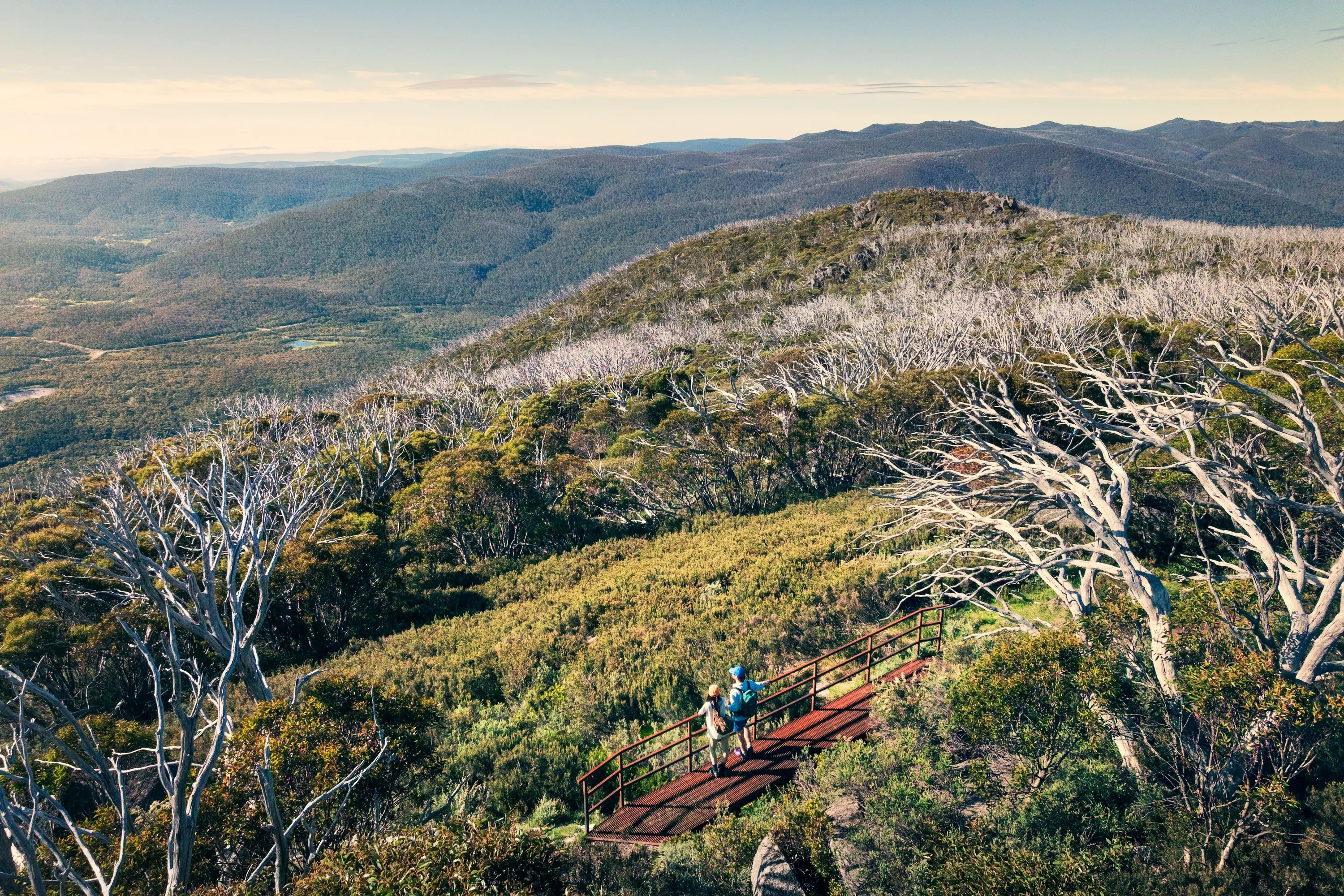 A couple takes in the amazing views during a hike along the Snowies Alpine Walk, - Perisher to Bullocks Flat, Snowy Mountains, Snowy Mountains