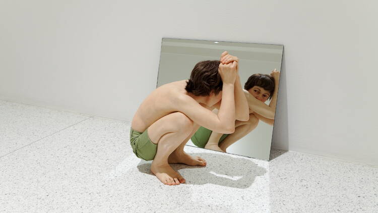 Ron Mueck 'Crouching Boy in Mirror A crouching boy in front of a mirror sculpture